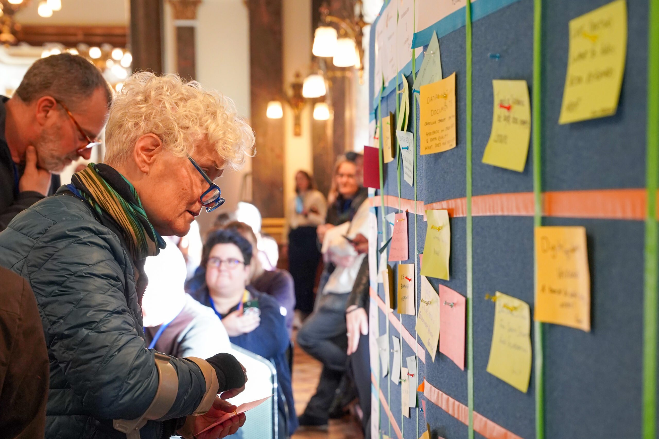 people looking at grid of info at UK govcamp
